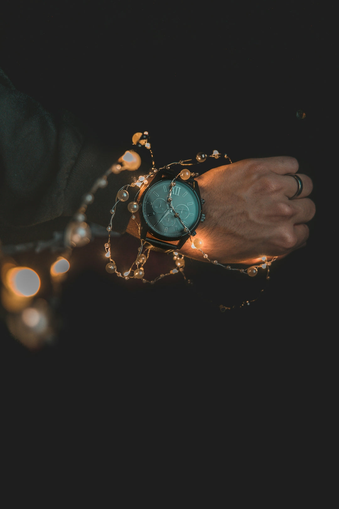 person wearing teal and black analog watch