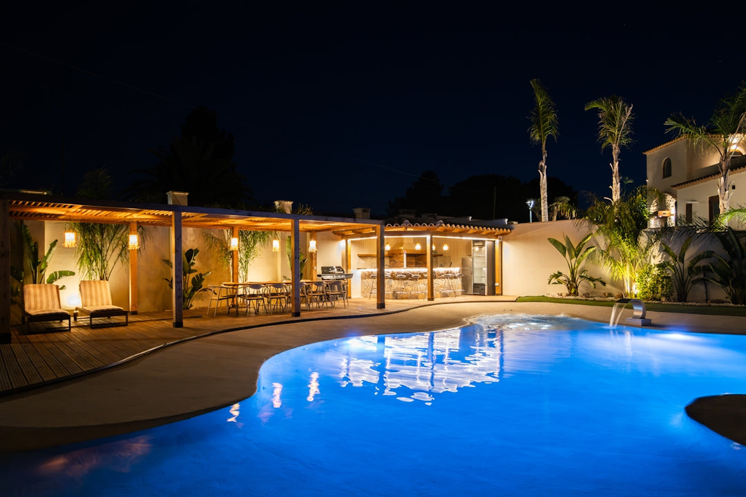 Luxury pool and patio area at night