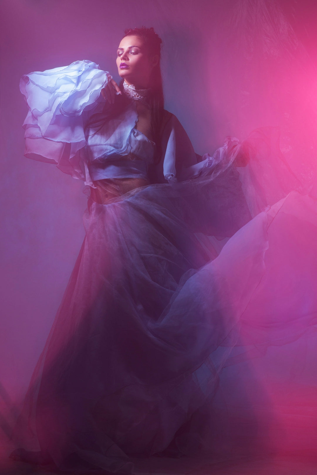 Woman in flowing dress with dramatic lighting