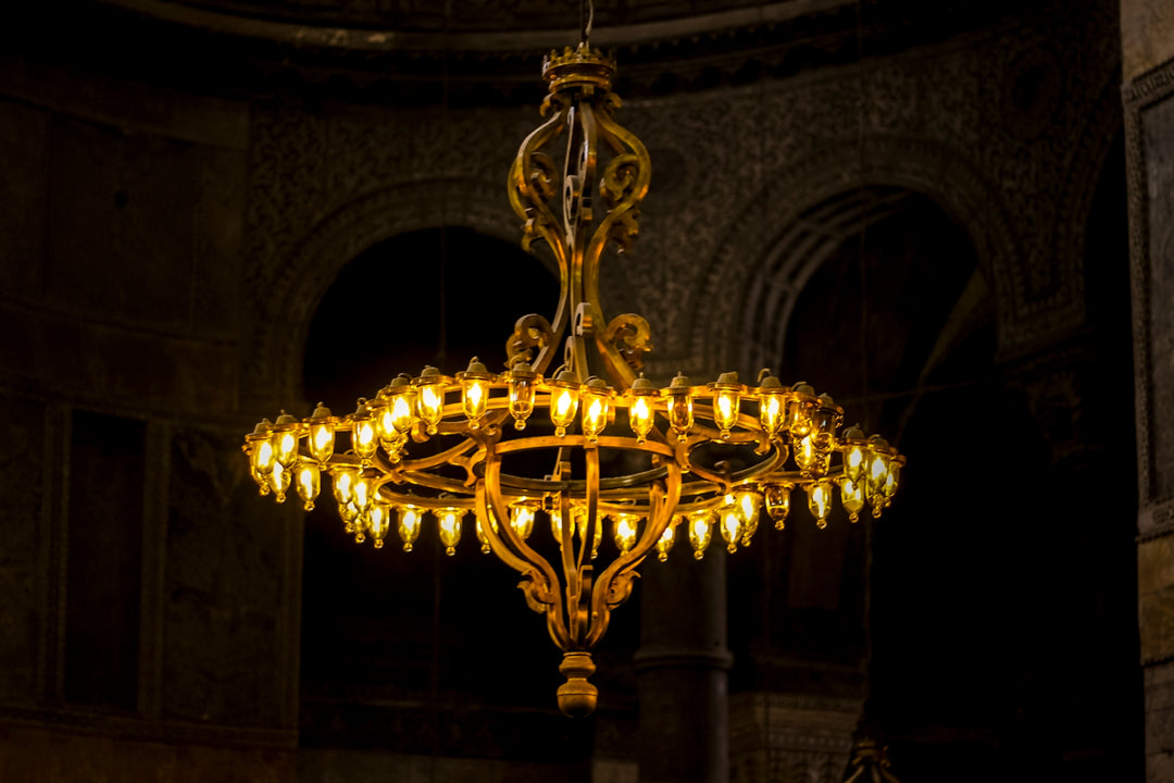 An ornate golden chandelier with many lights