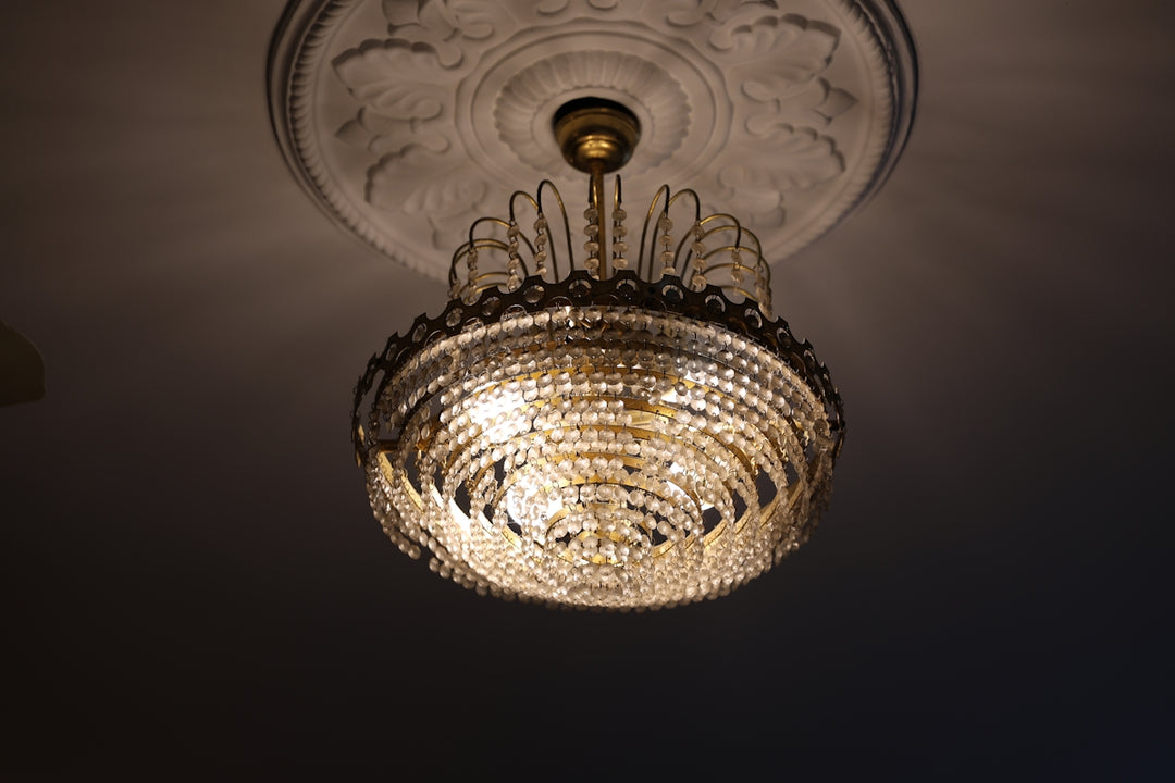 An ornate crystal chandelier hangs from ceiling