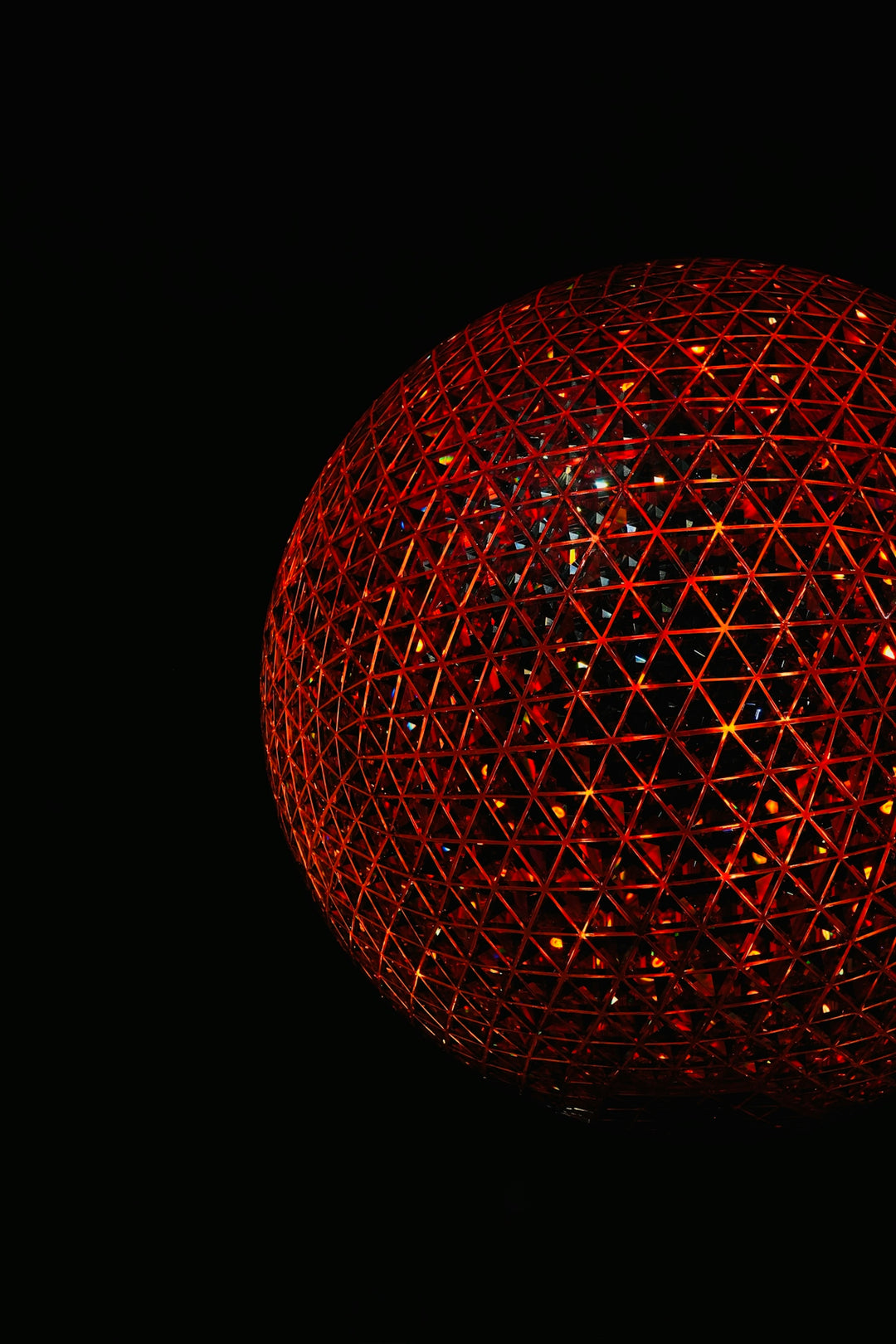 A glowing red geometric sphere on a black background