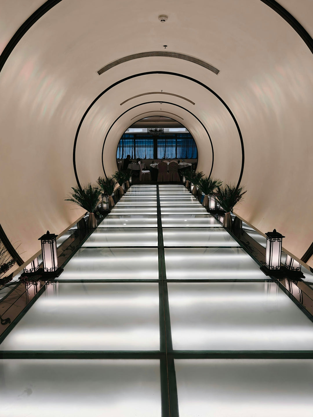 Modern illuminated walkway leading to a restaurant
