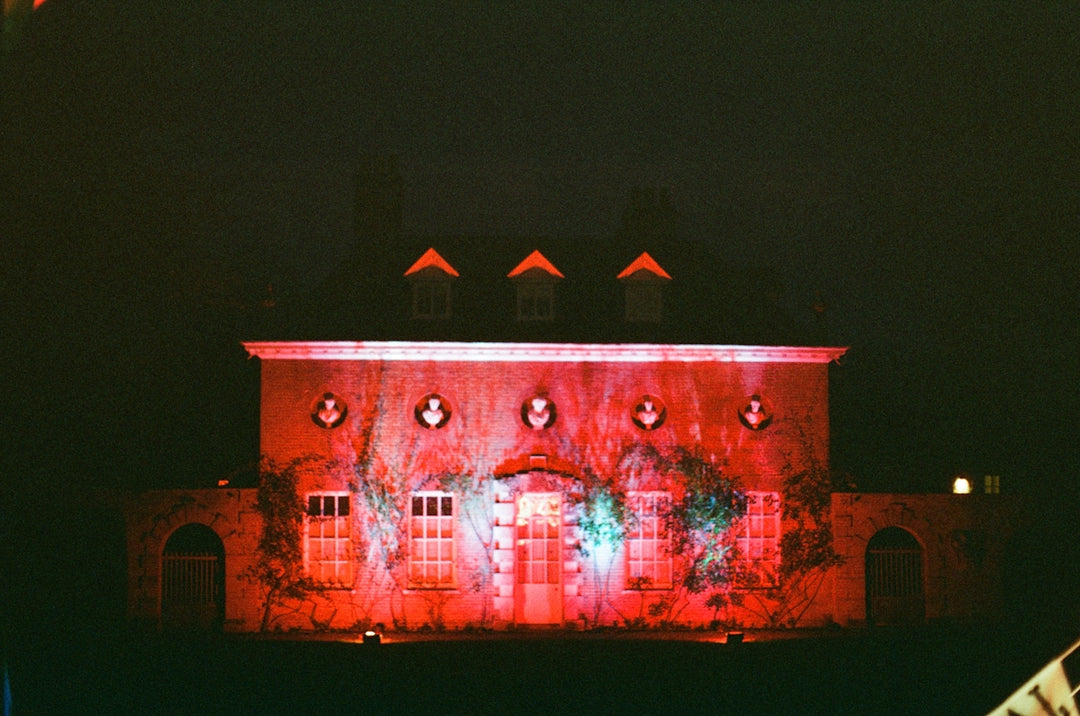 Building illuminated with red and green lights at night