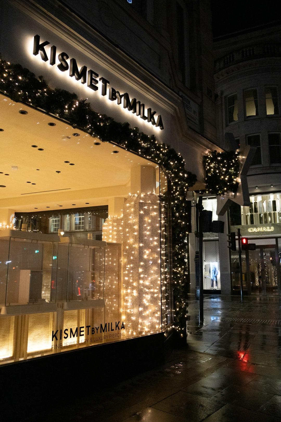 Storefront decorated with christmas lights at night