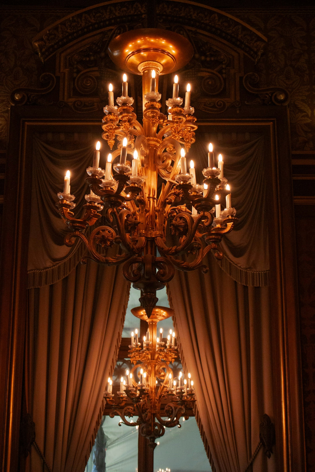 Ornate golden chandelier with many lit candles