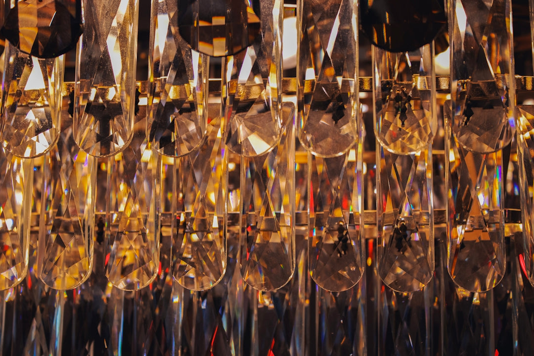 Close up of a crystal chandelier with warm lighting.