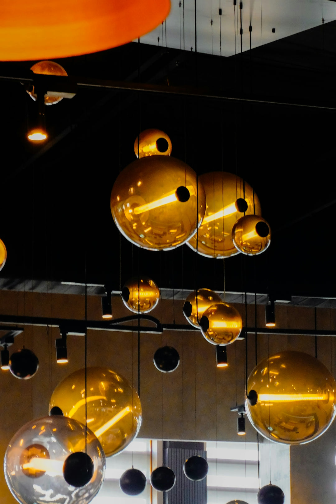 Modern golden sphere pendant lights hanging indoors