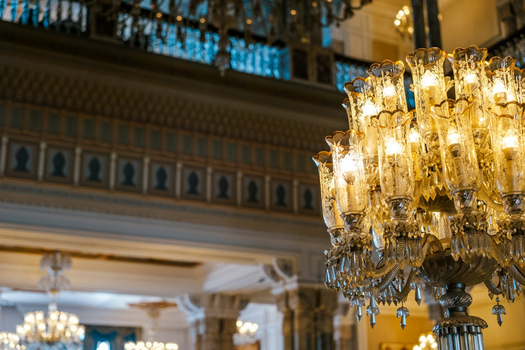 A grand, ornate chandelier illuminates a luxurious hall